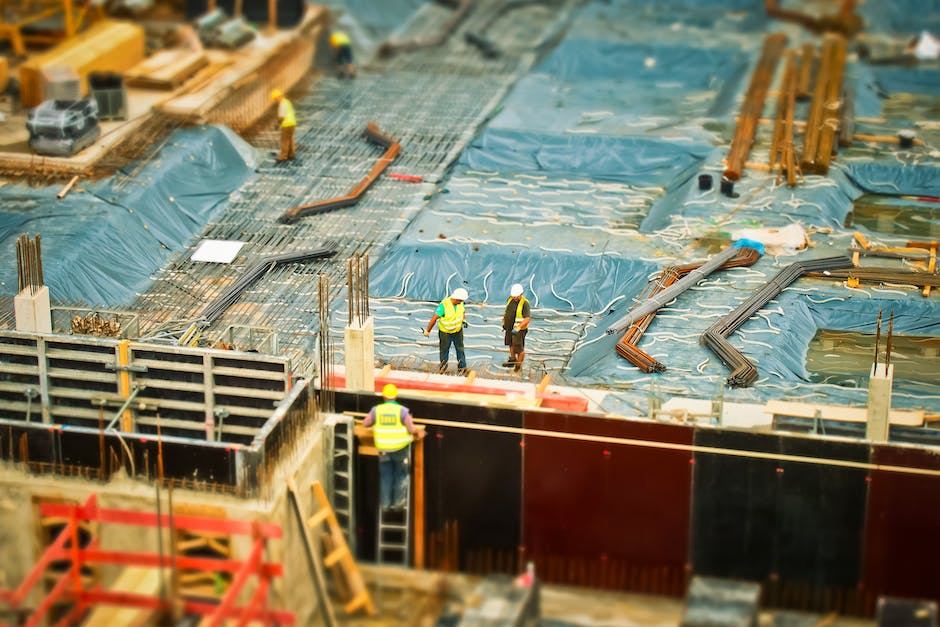 A group of workers wearing protective gear while handling asbestos materials